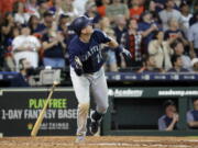 Seattle Mariners’ Ryon Healy drops his bat after hitting a home run against the Houston Astros during the ninth inning of a baseball game Sunday, Aug. 12, 2018, in Houston. (AP Photo/David J.