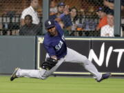 Seattle Mariners center fielder Guillermo Heredia catches a fly ball by Houston Astros’ Tony Kemp during the eighth inning of a baseball game Saturday, Aug. 11, 2018, in Houston. (AP Photo/David J.