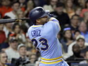 Seattle Mariners’ Nelson Cruz watches a two-run double against the Houston Astros during the eighth inning of a baseball game Friday, Aug. 10, 2018, in Houston. (AP Photo/David J.