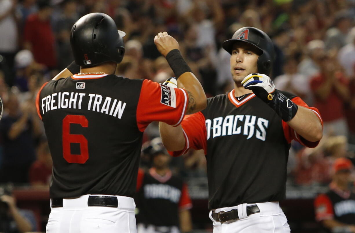 Arizona Diamondbacks' Paul Goldschmidt celebrates with David Peralta (6) after hitting a three-run home run against the Seattle Mariners in the third inning during a baseball game, Sunday, Aug. 26, 2018, in Phoenix.