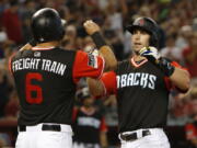 Arizona Diamondbacks' Paul Goldschmidt celebrates with David Peralta (6) after hitting a three-run home run against the Seattle Mariners in the third inning during a baseball game, Sunday, Aug. 26, 2018, in Phoenix.