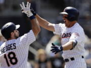 San Diego Padres’ Hunter Renfroe, right, celebrates with teammate Austin Hedges (18) after hitting a three-run home run in the third inning of a baseball game against the Seattle Mariners, Wednesday, Aug. 29, 2018, in San Diego.