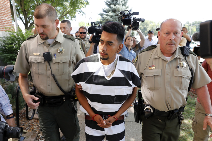 Cristhian Bahena Rivera is escorted into the Poweshiek County Courthouse for his initial court appearance Wednesday in Montezuma, Iowa. Rivera is charged with first-degree murder in the death of Mollie Tibbetts, who disappeared July 18 from Brooklyn, Iowa.