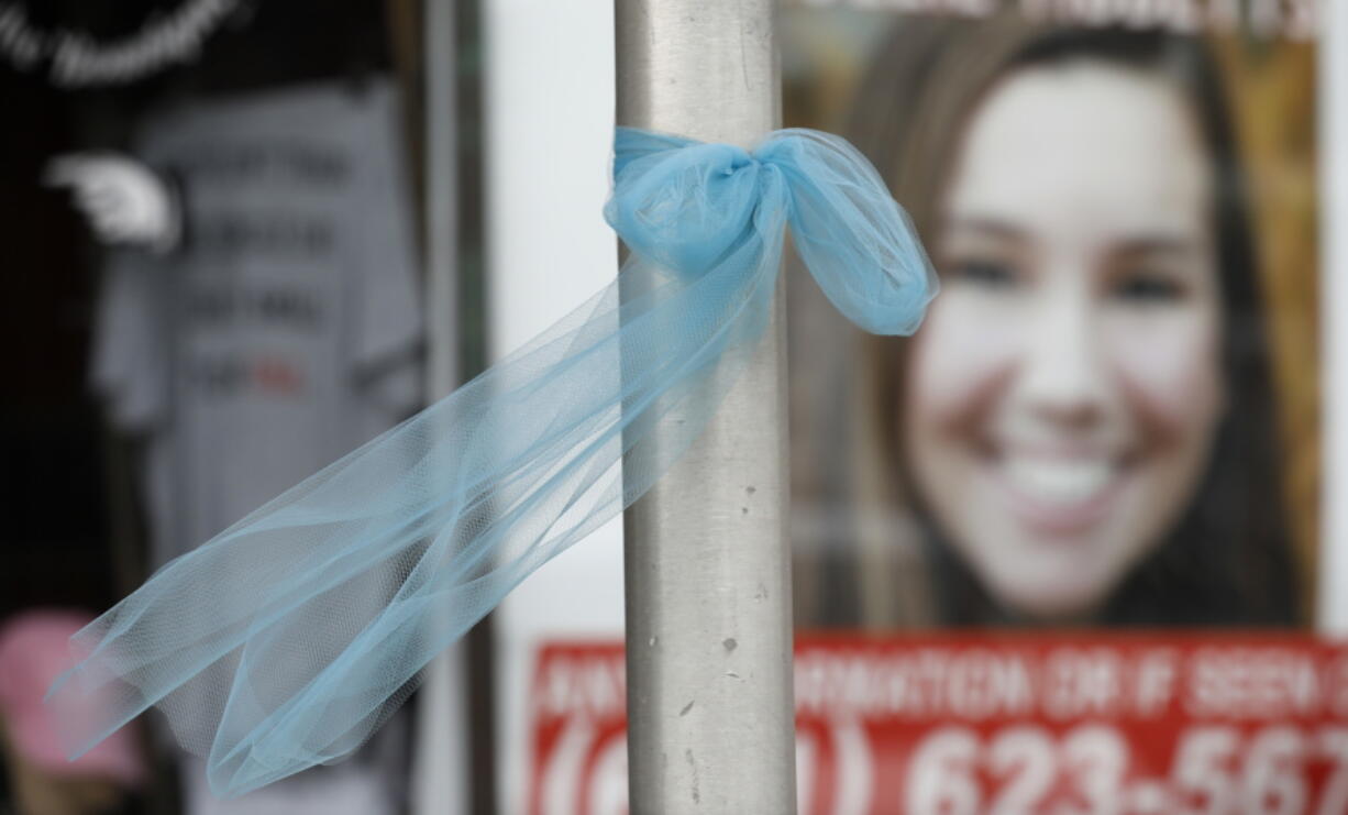 A ribbon for missing University of Iowa student Mollie Tibbetts hangs on a light post in Brooklyn, Iowa. The funeral for Tibbetts will be held Sunday, Aug. 26, in the gymnasium of BGM High School in Brooklyn, the city of 1,500 in central Iowa where she grew up. Tibbetts graduated from the school in 2017.