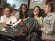 From left: Masey Tucker, Kaytlin Holgerson, Jordan Holgerson and Taylor Lavigne joke with the media about Jordan Holgerson's injuries while speaking at PeaceHealth Southwest Medical on Thursday. Holgerson was injured when she was pushed off a bridge at Moulton Falls Regional Park on Tuesday.