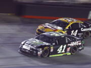 Kurt Busch (41) drives below Clint Bowyer Jr. during the NASCAR Cup Series auto race Saturday, Aug. 18, 2018, in Bristol, Tenn.