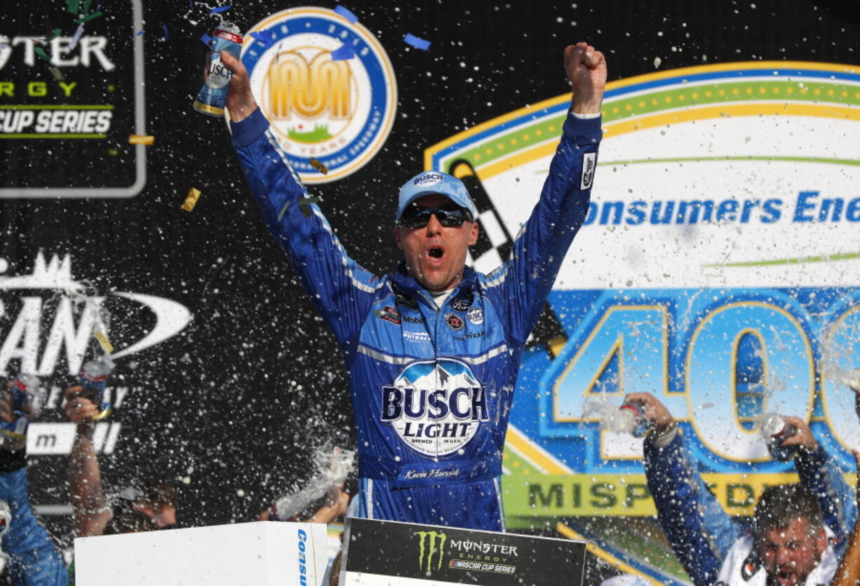 Kevin Harvick celebrates his victory after a NASCAR Cup Series auto race at Michigan International Speedway in Brooklyn, Mich., Sunday, Aug. 12, 2018.