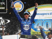 Kevin Harvick celebrates his victory after a NASCAR Cup Series auto race at Michigan International Speedway in Brooklyn, Mich., Sunday, Aug. 12, 2018.