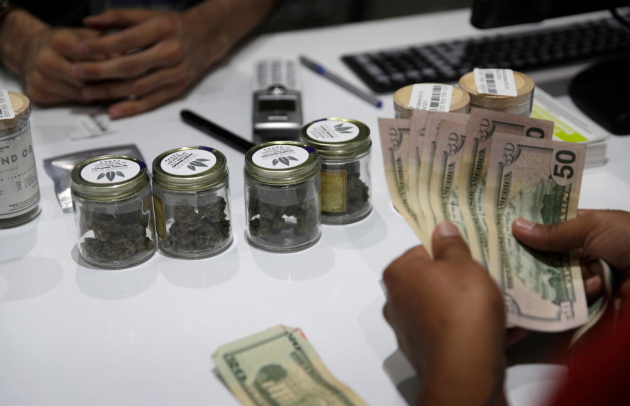 A person buys marijuana at the Essence cannabis dispensary in Las Vegas on July 1, 2017.