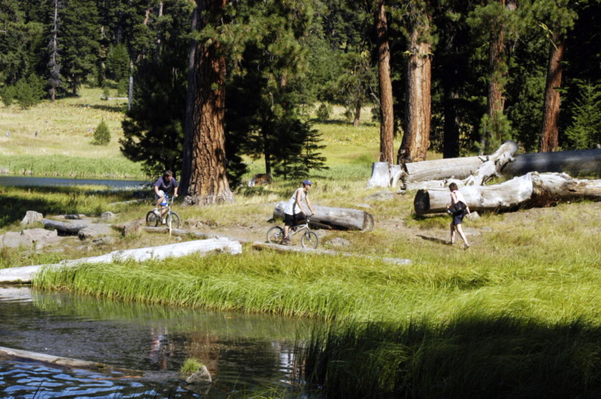 Cyclists and hikers share a trail along Walton Lake in the Ochoco National Forest on Aug. 6, 2005, near Prineville, Ore. A federal magistrate in Oregon has rejected a proposal to create a network of trails for off-road vehicles in the Ochoco National Forest, putting the plan in jeopardy.