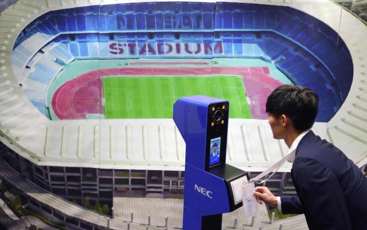 A staff demonstrates a new face recognition system used for the Tokyo 2020 Olympic and Paralympic Games during a press conference in Tokyo Tuesday, Aug. 7, 2018. The NeoFace technology developed by NEC Corp. will be used across the Olympics for the first time as Tokyo organizers work to keep security tight and efficient at dozens of venues during the 2020 Games.