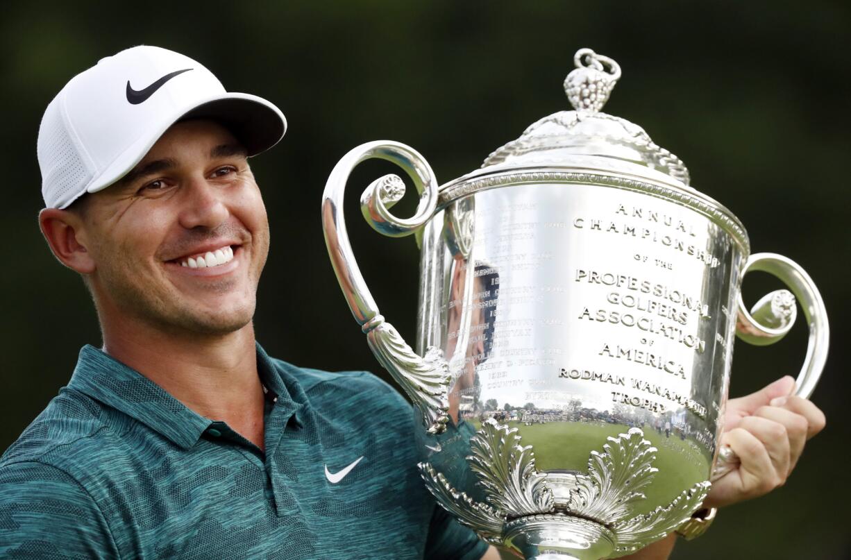 Brooks Koepka holds the Wanamaker Trophy after he won the PGA Championship golf tournament at Bellerive Country Club, Sunday, Aug. 12, 2018, in St. Louis.