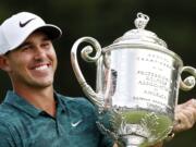 Brooks Koepka holds the Wanamaker Trophy after he won the PGA Championship golf tournament at Bellerive Country Club, Sunday, Aug. 12, 2018, in St. Louis.