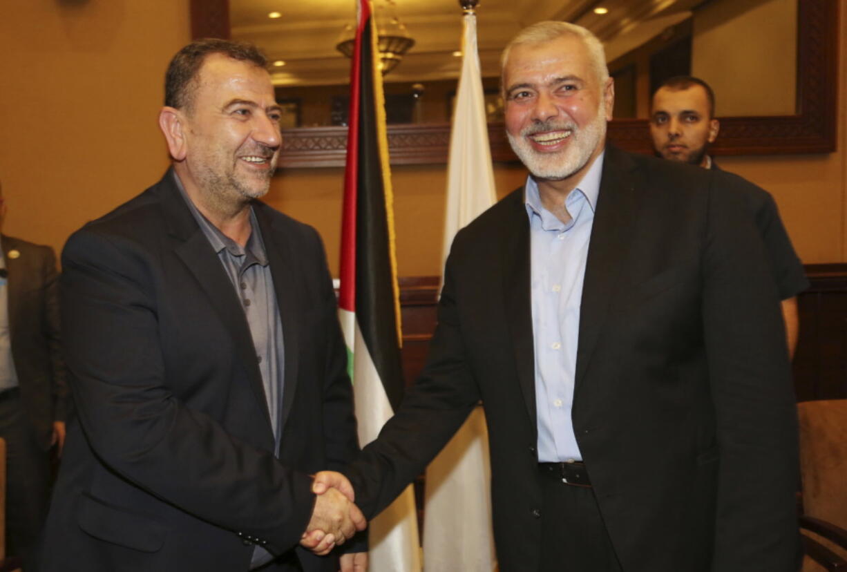 In this photo released by the Hamas Media Office, Ismail Haniyeh, right, the head of the Hamas political bureau, shakes hands with his deputy Saleh Arouri upon his arrival in Gaza from Cairo, Egypt, in Gaza City, on Thursday. Egypt is trying to broker a broad cease-fire deal between Israel and Gaza’s Hamas rulers that is to pave the way for Gaza’s reconstruction and an eventual prisoner swap, senior Hamas officials said Thursday. Repeated cease-fire deals over the years collapsed, but there were signs of possible momentum toward a new agreement, after weeks of escalation along the Gaza-Israel frontier.