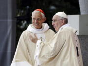 Cardinal Donald Wuerl, archbishop of Washington, left, looks toward the crowd with Pope Francis following a Mass outside the Basilica of the National Shrine of the Immaculate Conception in Washington. Wuerl wrote to priests to defend himself on the eve of the scheduled Tuesday, Aug. 14, 2018, release of a grand jury report investigating child sexual abuse in six of Pennsylvania’s Roman Catholic dioceses.