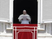 In this Sunday, Aug. 19, 2018 file photo, Pope Francis prays for the victims of the Kerala floods during the Angelus noon prayer in St.Peter's Square, at the Vatican. Pope Francis has issued a letter to Catholics around the world condemning the "crime" of priestly sexual abuse and cover-up and demanding accountability, in response to new revelations in the United States of decades of misconduct by the Catholic Church.