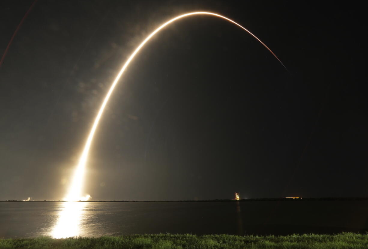 A Falcon 9 SpaceX rocket lifts off from the Cape Canaveral Air Force Station Complex 40 launch pad as seen through a time exposure in Cape Canaveral, Fla., on Tuesday. The payload, named Merah Putih, is a geostationary commercial communications satellite.