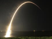 A Falcon 9 SpaceX rocket lifts off from the Cape Canaveral Air Force Station Complex 40 launch pad as seen through a time exposure in Cape Canaveral, Fla., on Tuesday. The payload, named Merah Putih, is a geostationary commercial communications satellite.