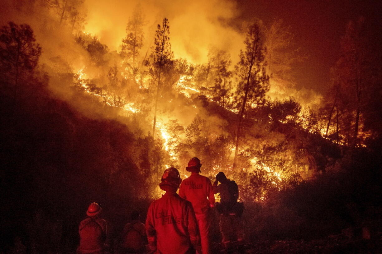 Firefighters monitor a backfire Aug. 7 while battling the Ranch Fire, part of the Mendocino Complex Fire near Ladoga, Calif. The years with the most acres burned by wildfires have some of the hottest temperatures, an Associated Press analysis of fire and weather data found. As human-caused climate change has warmed the world over the past 35 years, the land consumed in flames has more than doubled.