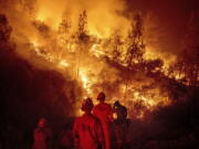 Firefighters monitor a backfire Aug. 7 while battling the Ranch Fire, part of the Mendocino Complex Fire near Ladoga, Calif. The years with the most acres burned by wildfires have some of the hottest temperatures, an Associated Press analysis of fire and weather data found. As human-caused climate change has warmed the world over the past 35 years, the land consumed in flames has more than doubled.