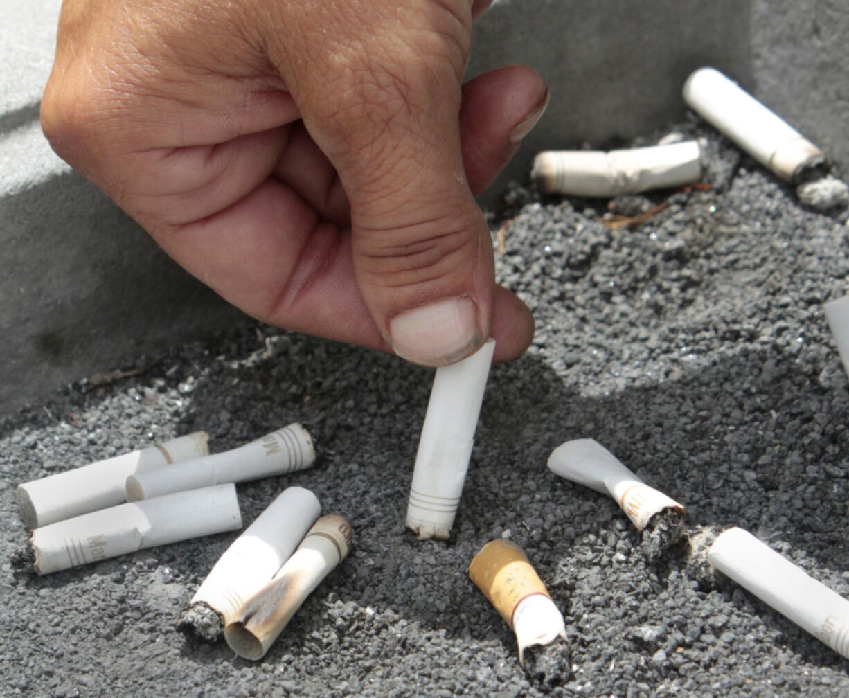 FILE - In this June 22, 2012 file photo, a smoker extinguishes a cigarette in an ash tray in Sacramento, Calif. If you quit smoking and gain weight, it may seem like you’re trading one set of health problems for another. But a new U.S. study released on Wednesday, Aug. 15, 2018 finds you’re still better off in the long run.