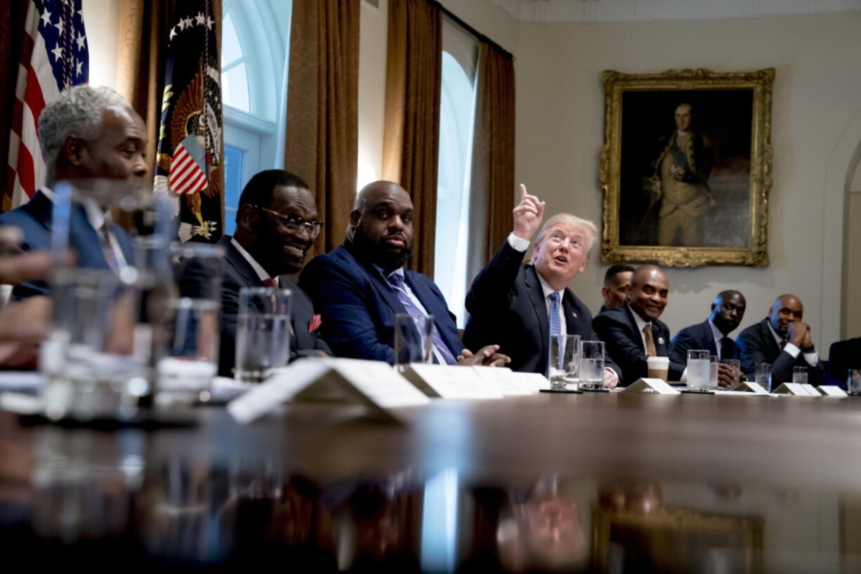 President Donald Trump points up to heaven as he speaks during a meeting with inner city pastors in the Cabinet Room of the White House in Washington, Wednesday, Aug. 1, 2018.