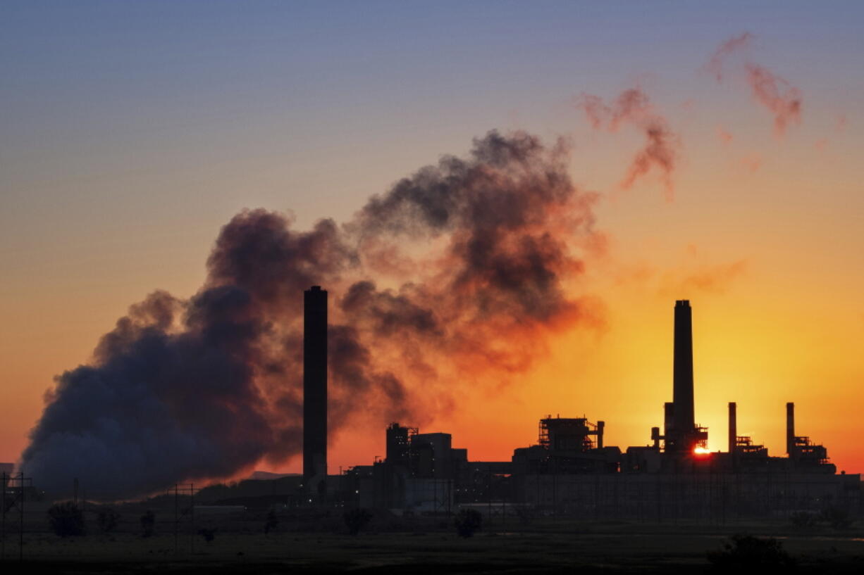 The Dave Johnson coal-fired power plant is silhouetted against the morning sun in Glenrock, Wyo. The Trump administration on Tuesday proposed a major rollback of Obama-era regulations on coal-fired power plants, striking at one of the former administration’s legacy programs to rein in climate-changing fossil-fuel emissions. (AP Photo/J.