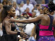 Serena Williams, left, meets her sister Venus Williams after their match during the third round of the U.S. Open tennis tournament, Friday, Aug. 31, 2018, in New York. Serena Williams won 6-1, 6-2.