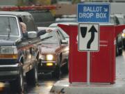 A steady stream of cars visits the ballot drop box at West 14th and Esther streets every major election. With ballots now including prepaid postage, voters do not need to stop by a ballot drop box if they want to return their ballot for free.