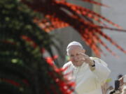 Pope Francis salutes as he arrives for his weekly general audience, at the Vatican on Wednesday.