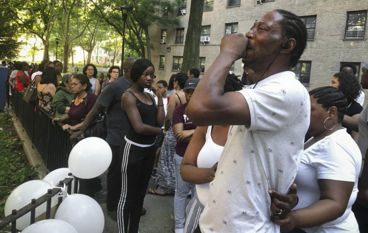 Lawrence Jackson, 42, center, the father of 15-year-old Kyon Jackson who was gunned down the previous day at the Bushwick Houses, grieves during a vigil at the site of his son’s killing, in the Brooklyn borough of New York. Sixteen people between the ages of 10 and 18 have been killed in the city, already matching last year’s total.