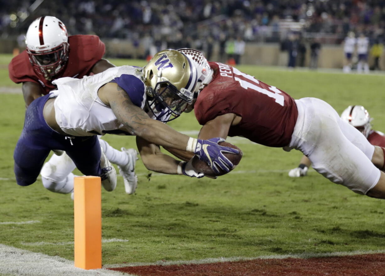 FILE - In this Nov. 10, 2017, file photo, Washington running back Myles Gaskin, left, scores a touchdown against Stanford during the second half of an NCAA college football game in Stanford, Calif. Gaskin is likely to rewrite the record book for No. 6 Washington by the end of his senior season. But he’ll have help this season in the form of sophomore Salvon Ahmed. The duo get a major test out of the gates against No. 9 Auburn.