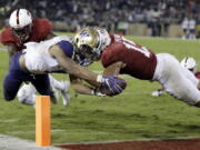 FILE - In this Nov. 10, 2017, file photo, Washington running back Myles Gaskin, left, scores a touchdown against Stanford during the second half of an NCAA college football game in Stanford, Calif. Gaskin is likely to rewrite the record book for No. 6 Washington by the end of his senior season. But he’ll have help this season in the form of sophomore Salvon Ahmed. The duo get a major test out of the gates against No. 9 Auburn.