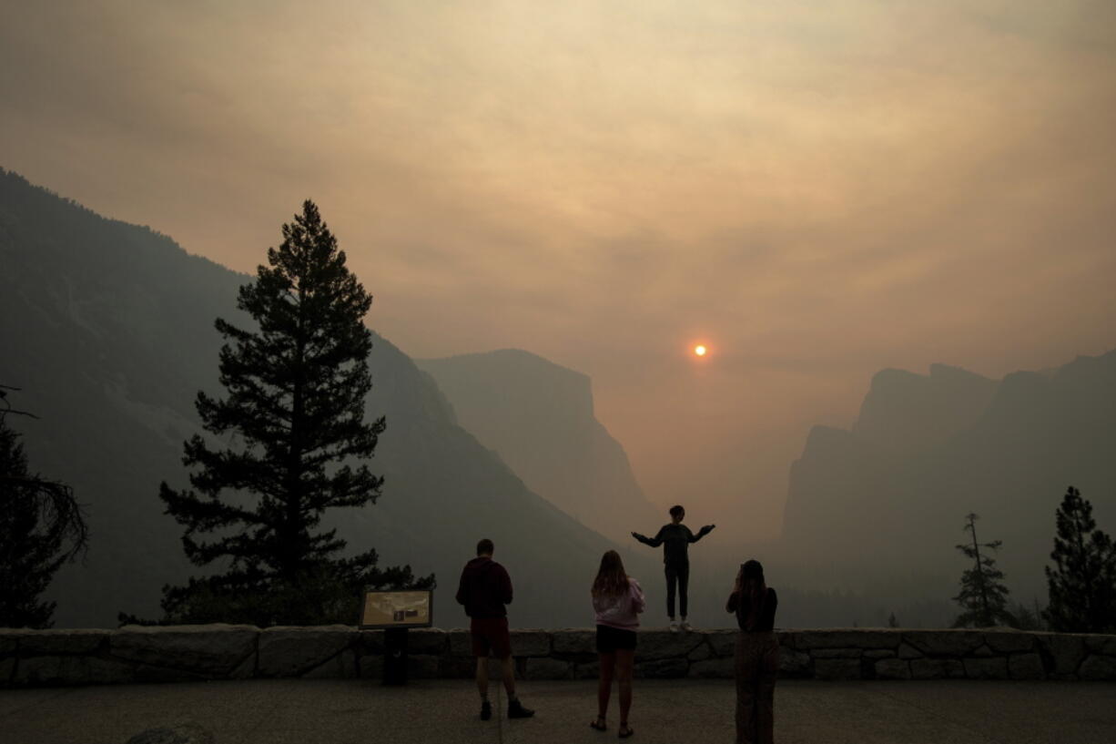 Hannah Whyatt poses for a friend’s photo as smoke from the Ferguson fire fills Yosemite Valley in Yosemite National Park, Calif., on July 25.