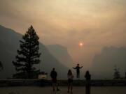 Hannah Whyatt poses for a friend’s photo as smoke from the Ferguson fire fills Yosemite Valley in Yosemite National Park, Calif., on July 25.