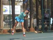 Victoria Sasinka, 13, of the US serves the ball, during an International Tennis Federation Tournament, at Harare Sports Club, in Harare, Monday, Aug. 6, 2018. As Zimbabwean soldiers opened fire on rioters, protesters and bystanders after a disputed election, teen-agers in an International Tennis Federation tournament were battling each other on hard courts a few kilometers (miles) from the deadly violence.