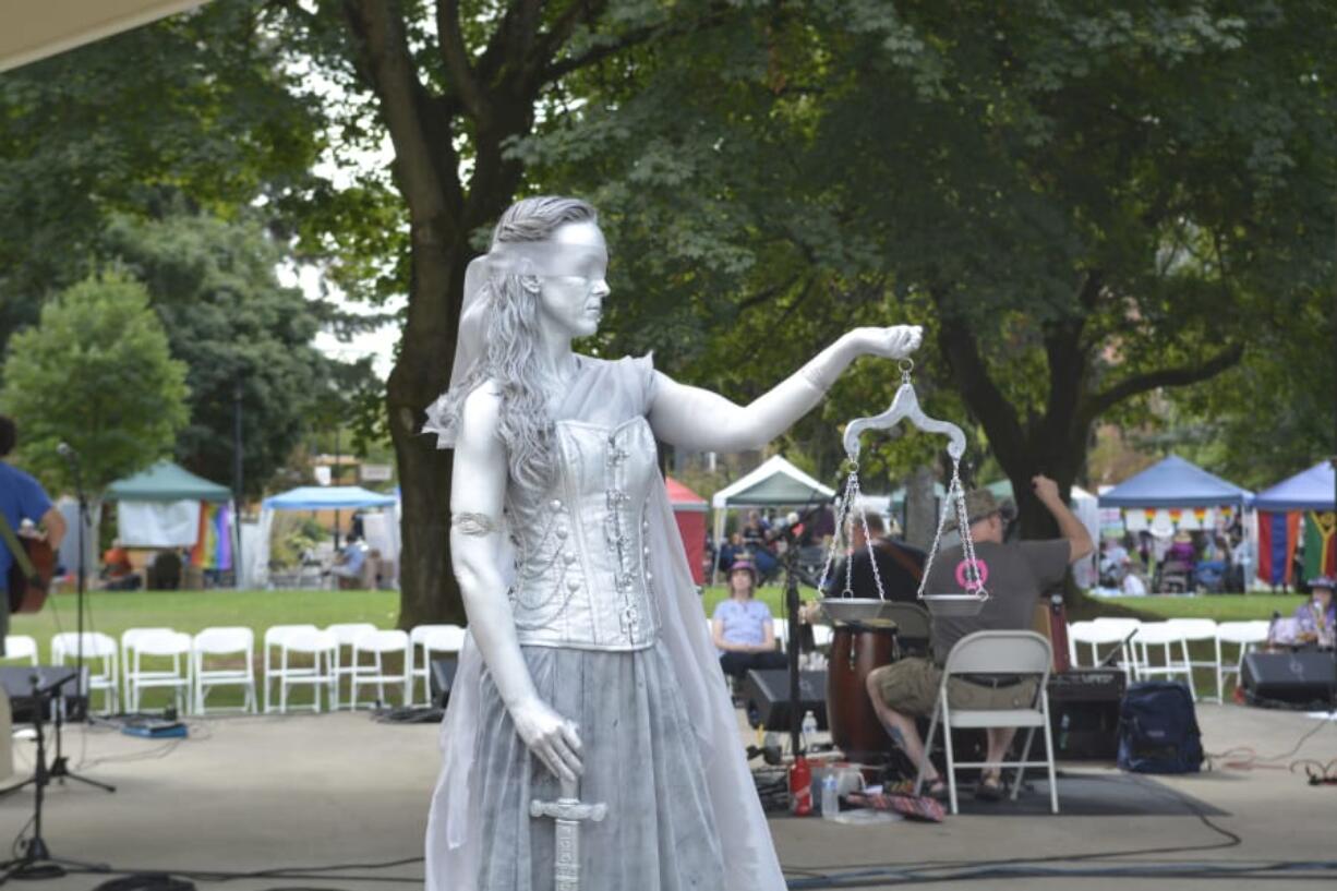 To complement the theme, the living statue Lady Justice, portrayed by Jaime Brooks, was on display at this year’s Peace and Justice Fair.