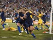Lindsey Horan (9), hugged by teammate McCall Zerboni after scoring a goal against Australia, is currently in the final stretch of her season with the Portland Thorns.