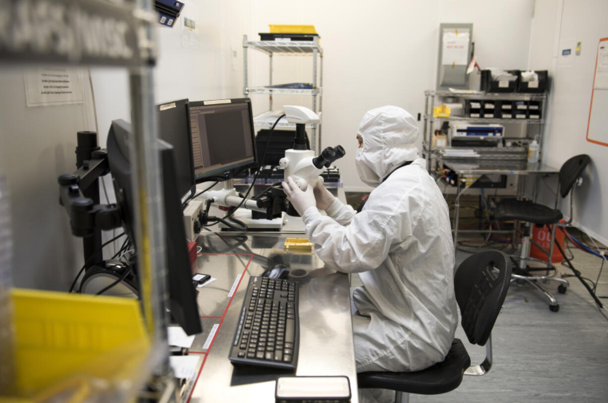 Senior manufacturing technician Phuong Pham of Portland demonstrates how he inspects the housing for direct diode lasers at nLight in Vancouver in 2017.