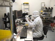 Senior manufacturing technician Phuong Pham of Portland demonstrates how he inspects the housing for direct diode lasers at nLight in Vancouver in 2017.