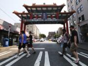 The tour group heads past the Chinese Gate on King Street dedicated a decade ago. King Street is considered the business heart of Chinatown International District, according to Don Wong, and the gate a welcoming symbol.