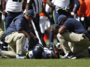 Seattle Seahawks wide receiver Doug Baldwin stays on the field injured during the first half of an NFL football game against the Denver Broncos Sunday, Sept. 9, 2018, in Denver.