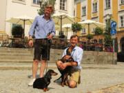 Dackelmuseum owners Oliver Storz, left, and Seppi Kublbeck, with their dachshunds Moni, left, and Little Seppi.