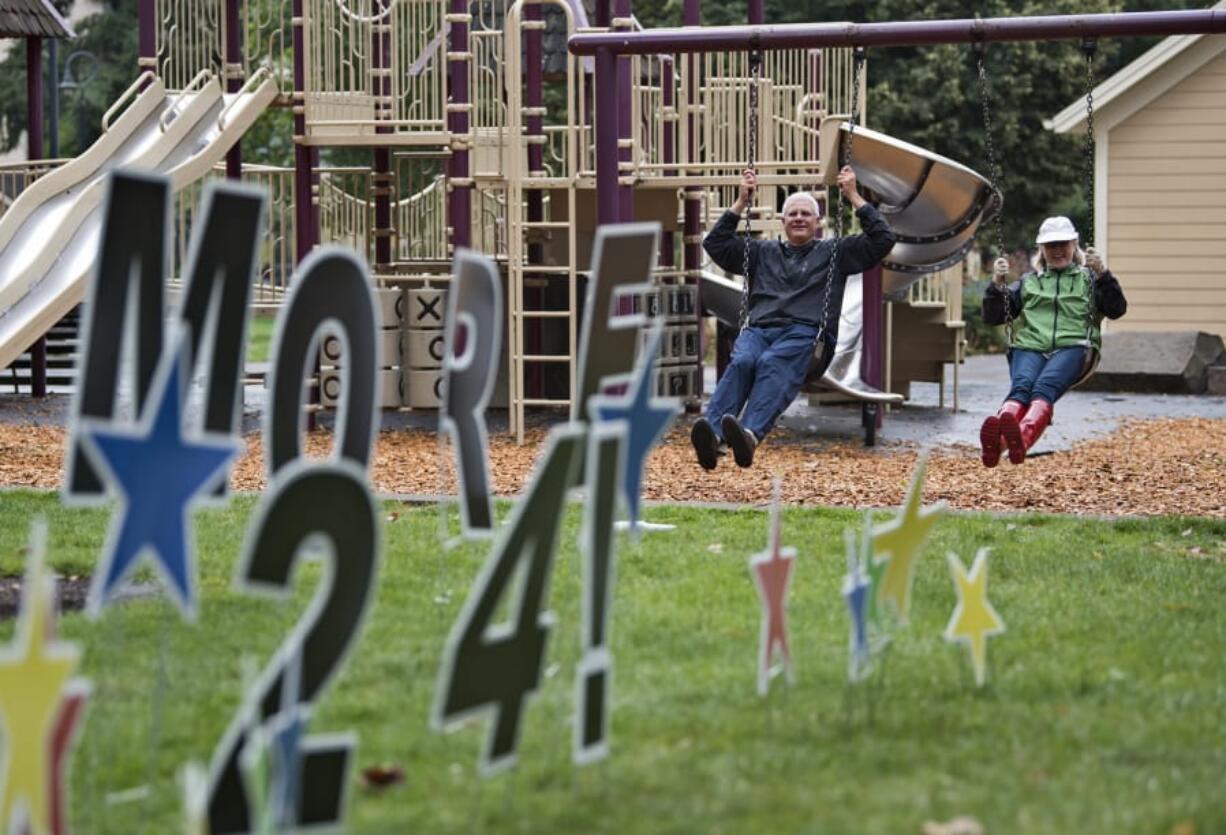 DeWayne Ledbetter of Portland and Lee Rafferty of Vancouver swing at Esther Short Park in downtown Vancouver with the Parks Foundation’s “Swing More 24” event created in conjunction with the fourth annual “Give More 24!” in 2017.