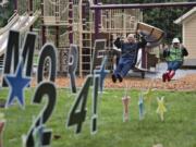 DeWayne Ledbetter of Portland and Lee Rafferty of Vancouver swing at Esther Short Park in downtown Vancouver with the Parks Foundation’s “Swing More 24” event created in conjunction with the fourth annual “Give More 24!” in 2017.