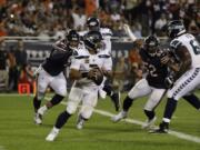 Seattle Seahawks quarterback Russell Wilson (3) looks to throw against the Chicago Bears during the second half of an NFL football game Monday, Sept. 17, 2018, in Chicago. (AP Photo/Nam Y.