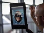 Station manager Chad Shane of SAS Airlines takes a traveler through the scanning process at Dulles International Airport. The facial scans can be compared with stored passport and visa photos.