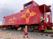 The author’s sons explore an old railcar secured on the tracks at the Railyard, a popular Santa Fe gathering spot.