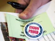 Teachers sign in a pick up their voting materials before the Camas Education Association general membership meeting on Aug. 2at Camas High School.