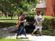 Milly Horsley, left in black shirt, and Gracie Robinson, right, walk to class at New Orleans Baptist Theological Seminary.